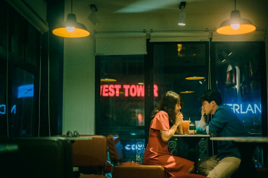 Couple enjoys drinks and a quiet evening inside a cozy café.